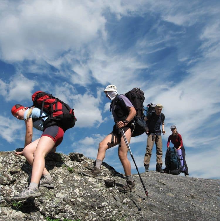 Four person the climb on rock