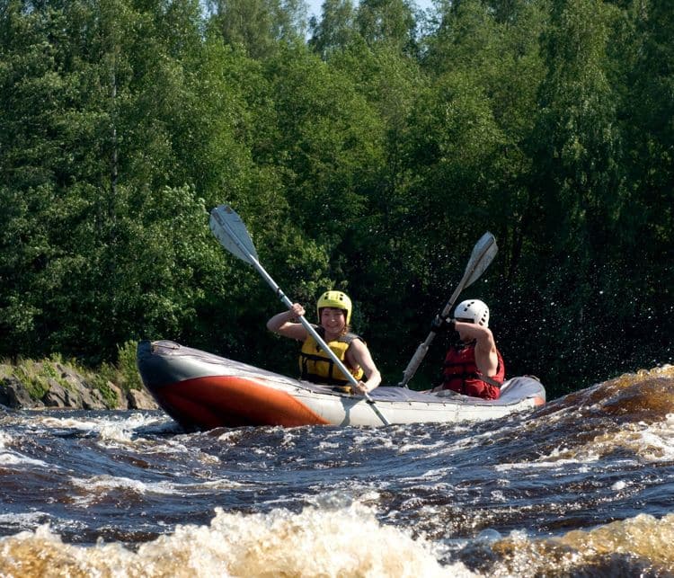 Kayakers sporting a kayak cuts through water