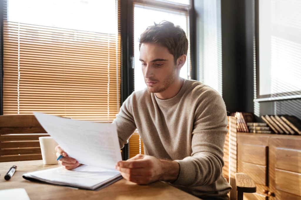 attractive young man office working with documents